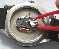 Battery retained by spring clip