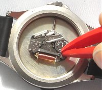 Battery retained by spring clip